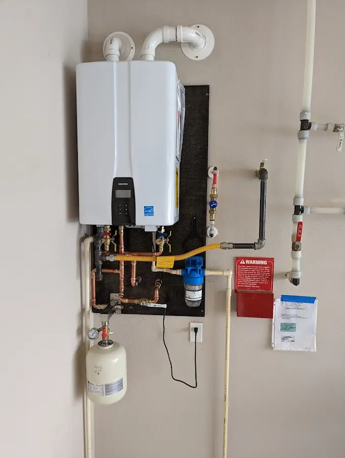 Professional plumber installing copper piping in a Alpharetta home